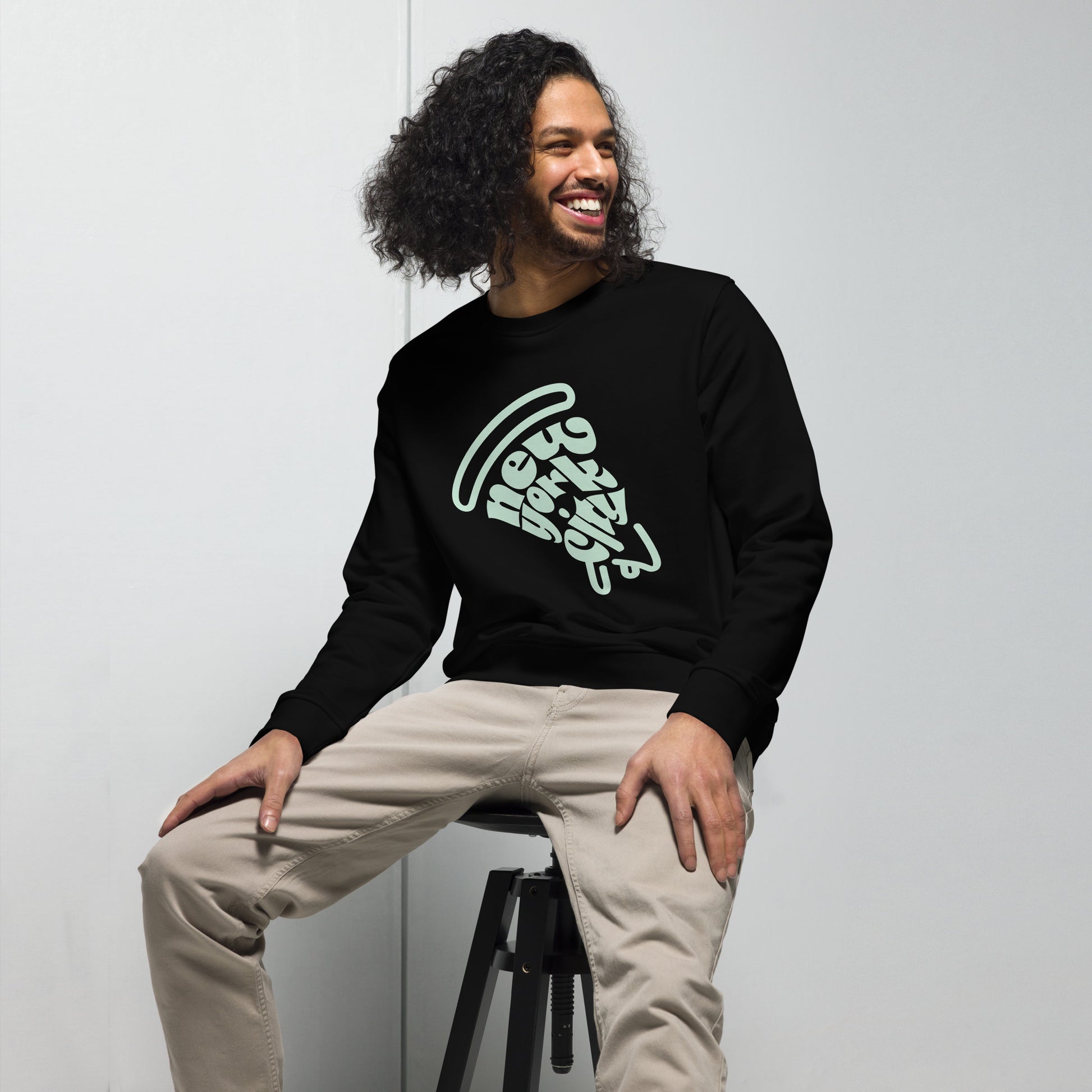 New York City Pizza Slice Unisex Crewneck Sweatshirt Black Adult Man sitting. City Crawl Adventures.